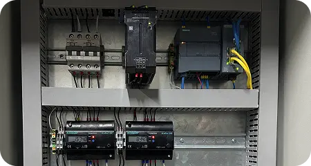 Industrial control panel integrating PLC, energy meters (3-phase analyzers), networking equipment, and edge computing devices