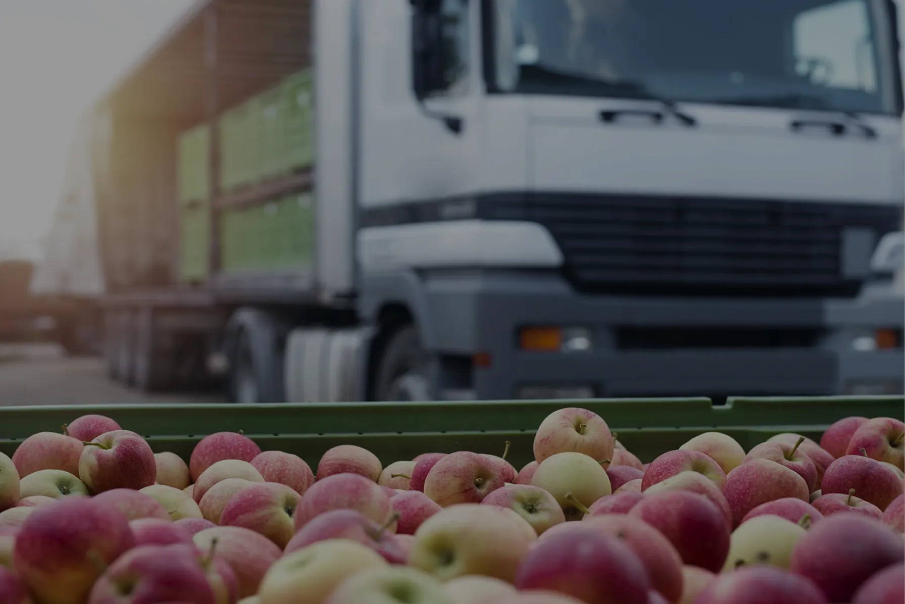 A truck with refrigeration equipment and containers of fresh produce, illustrating the transformation of food logistics with IoT-powered temperature monitoring in the cold chain.